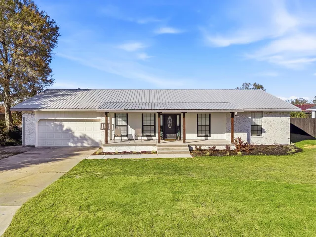 a front view of a house with a garden and porch