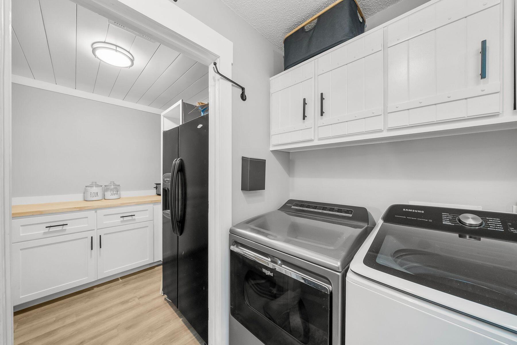 1218 Tuscany Road Panama City, FL 32405 - Photo 16 of 34 a kitchen with white cabinets and stainless steel appliances