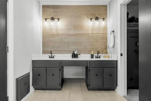 a bathroom with a double vanity sink and mirror