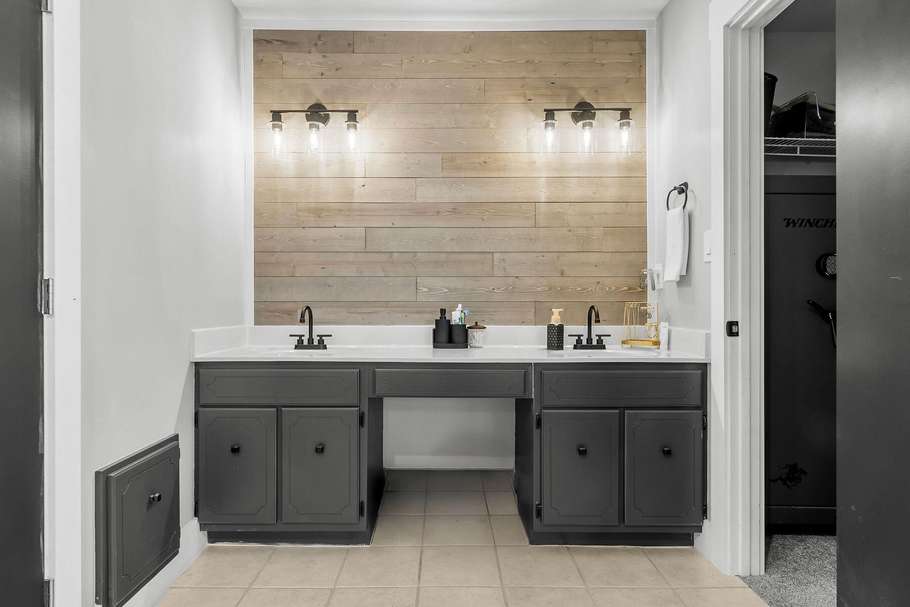 1218 Tuscany Road Panama City, FL 32405 - Photo 22 of 34 a bathroom with a double vanity sink and mirror