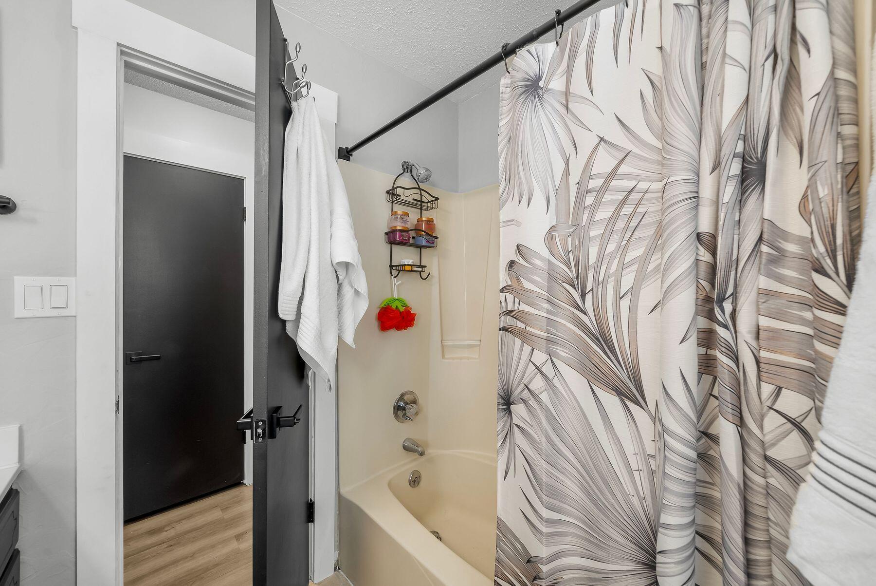 1218 Tuscany Road Panama City, FL 32405 - Photo 24 of 34 a bathroom with a bathtub and shower curtain