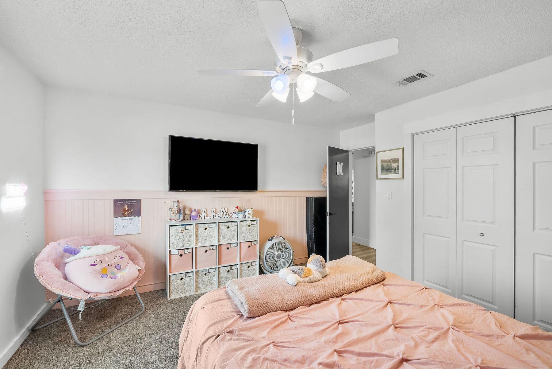 1218 Tuscany Road Panama City, FL 32405 - Photo 26 of 34 a bedroom with furniture and a flat screen tv