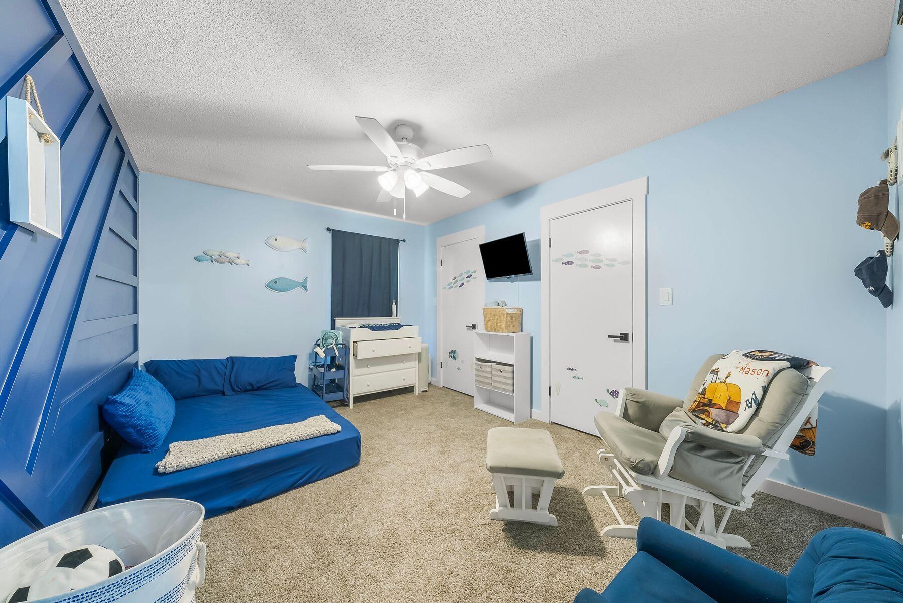 1218 Tuscany Road Panama City, FL 32405 - Photo 27 of 34 a living room with furniture and a flat screen tv