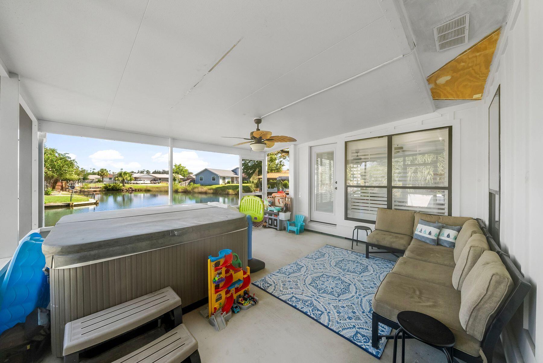 1218 Tuscany Road Panama City, FL 32405 - Photo 28 of 34 a room with furniture and a large window