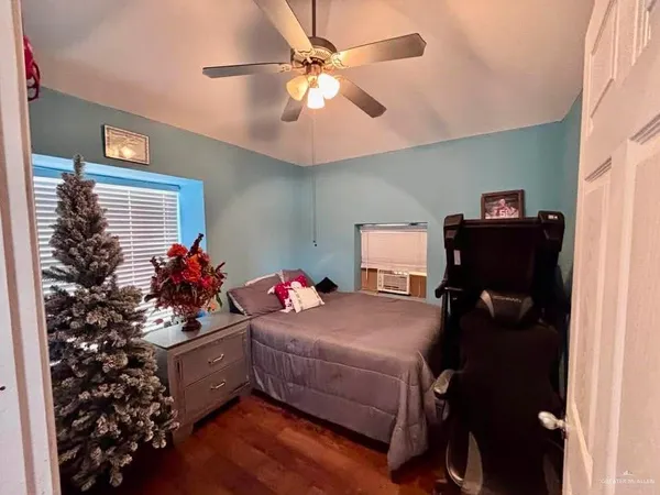 a bedroom with a bed and a chandelier