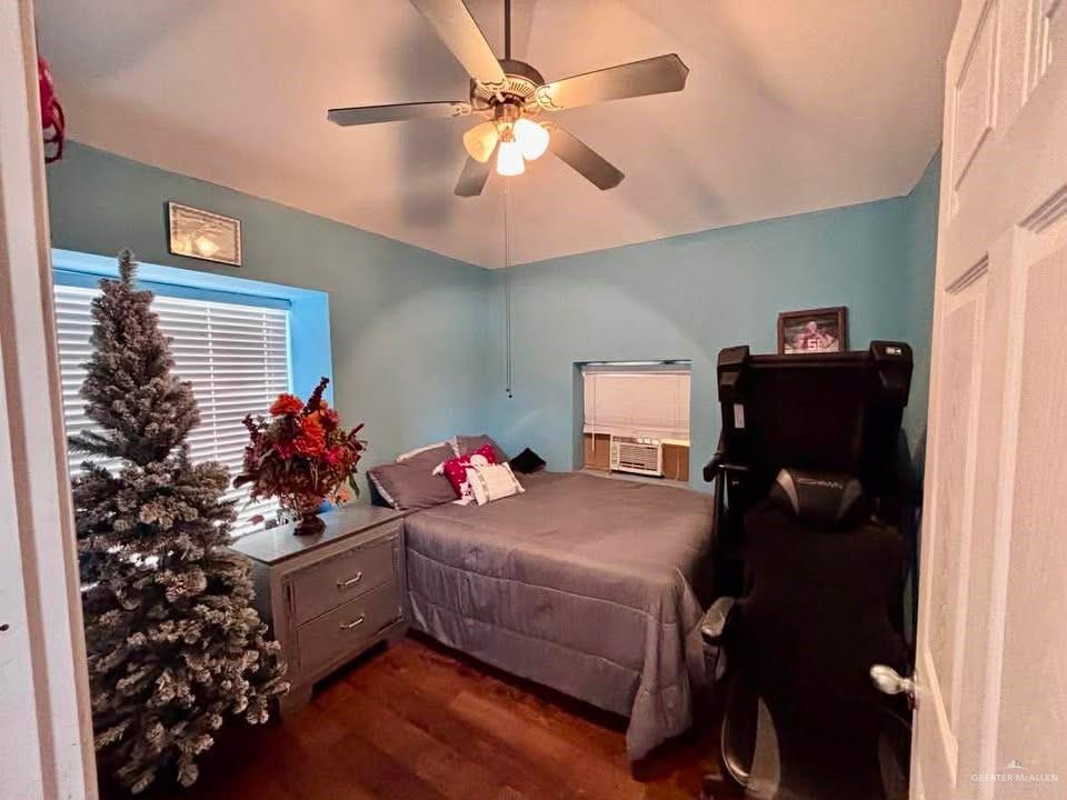 3113 Pradera Street Mission, TX 78574 - Photo 13 of 20 a bedroom with a bed and a chandelier