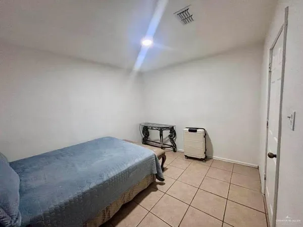 a bedroom with a bed and a rug