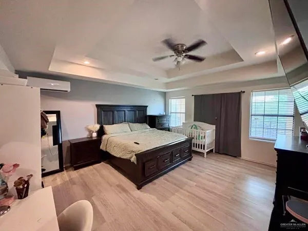 a spacious bedroom with a bed and window
