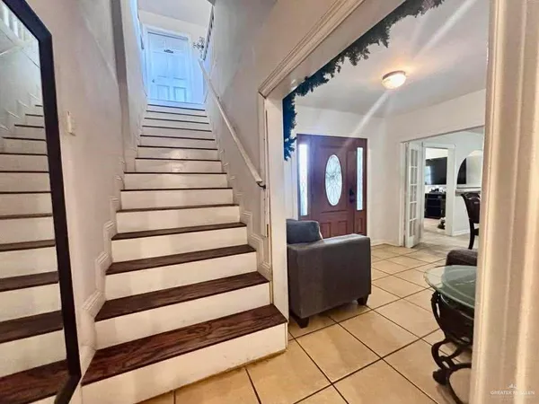 a view of a livingroom with furniture and staircase