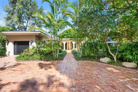 a view of a front of house with large trees