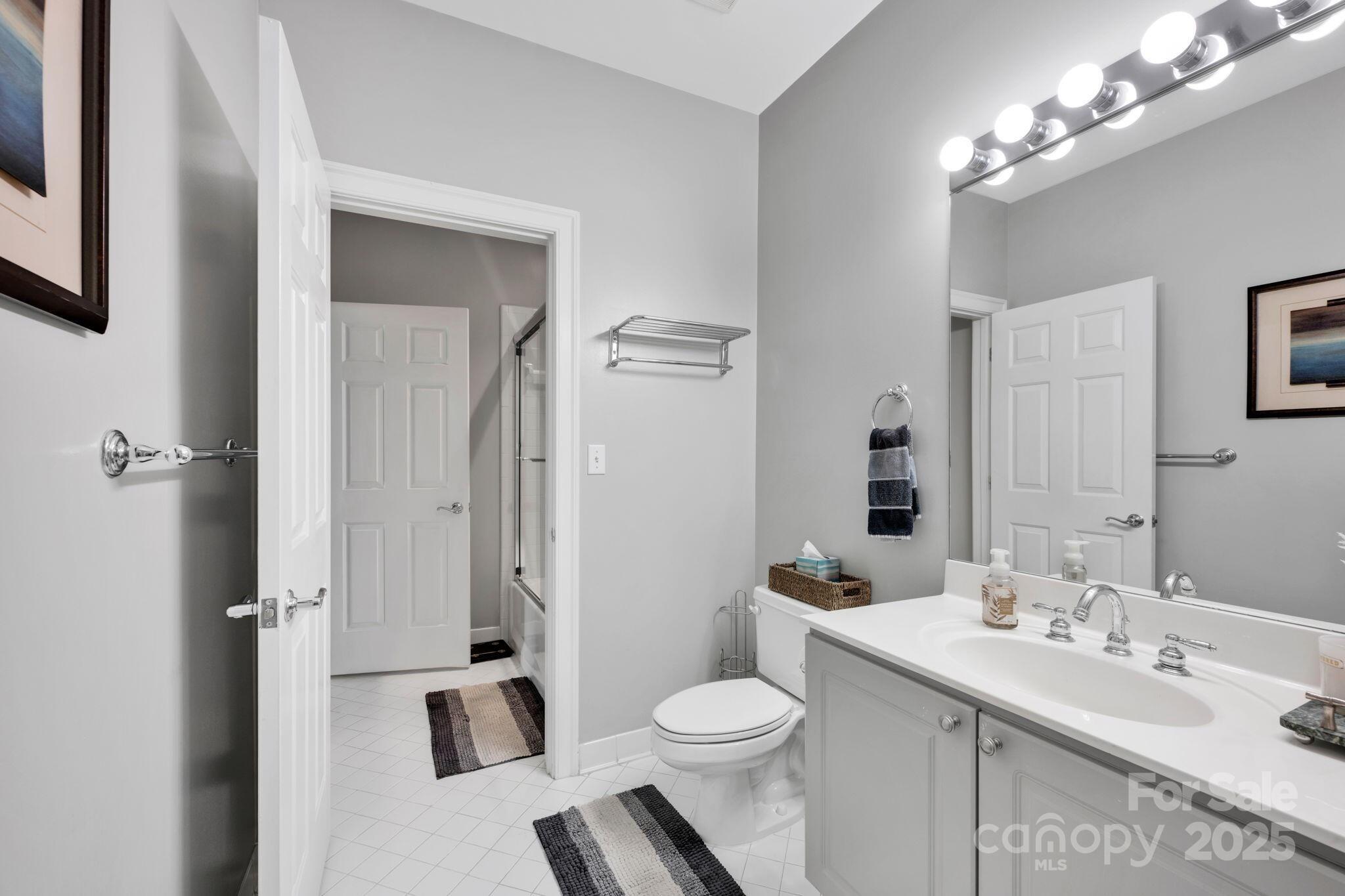 127 North Tryon Street, Unit 404 Charlotte, NC 28246 - Photo 18 of 22 a bathroom with a sink a toilet and shower