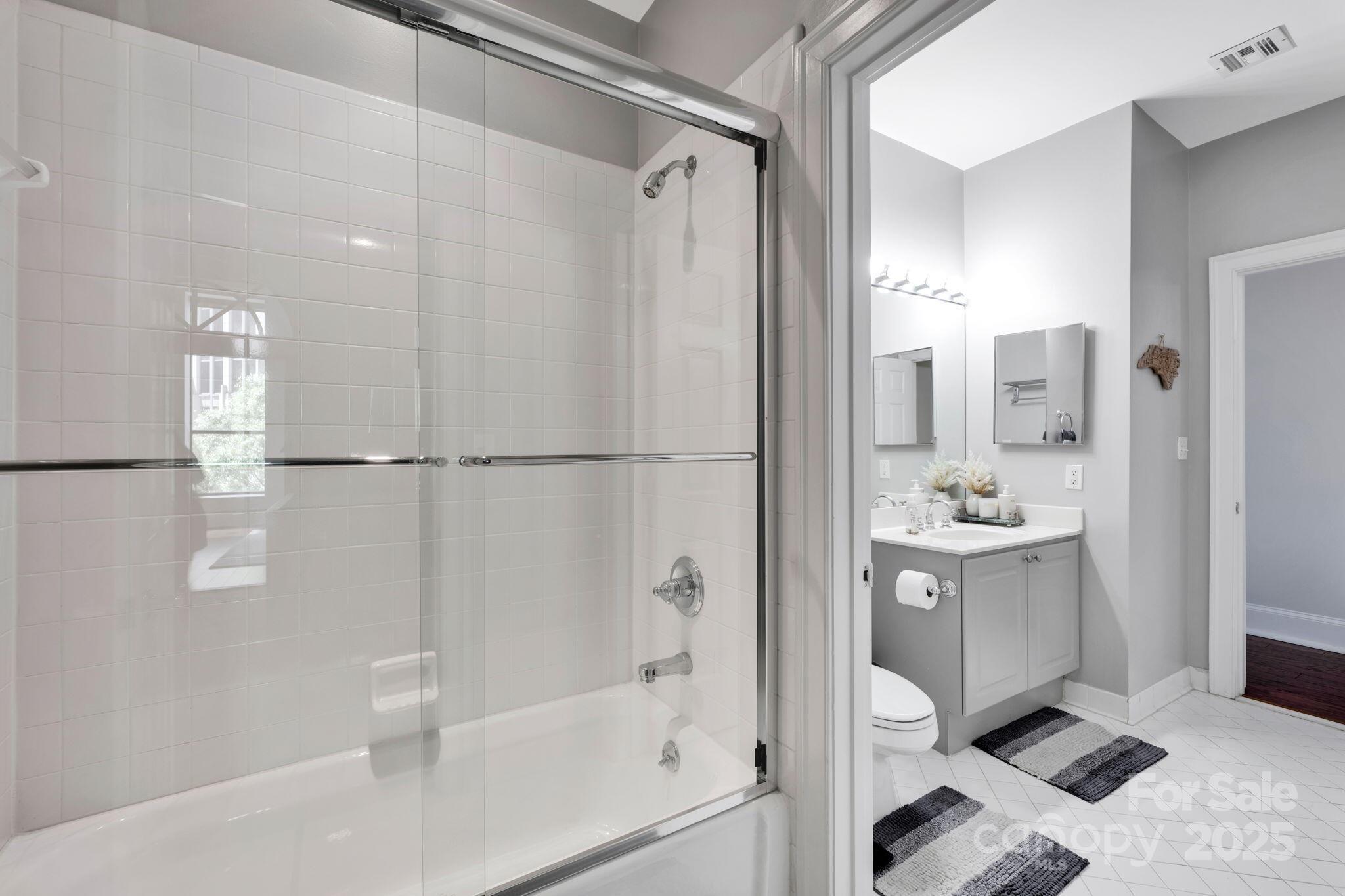 127 North Tryon Street, Unit 404 Charlotte, NC 28246 - Photo 19 of 22 a bathroom with a bathtub and a shower