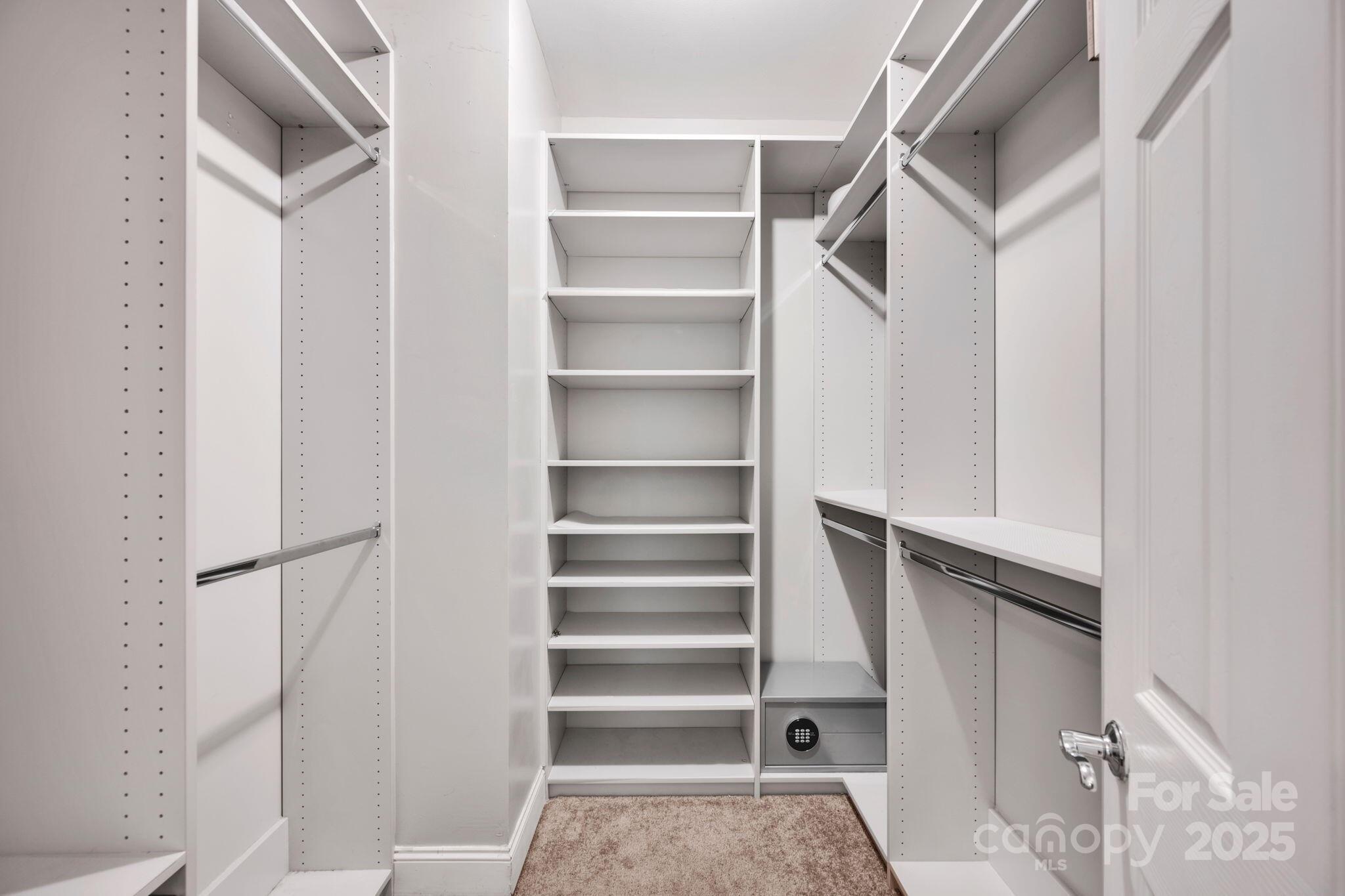 127 North Tryon Street, Unit 404 Charlotte, NC 28246 - Photo 7 of 22 a view of walk in closet with empty racks