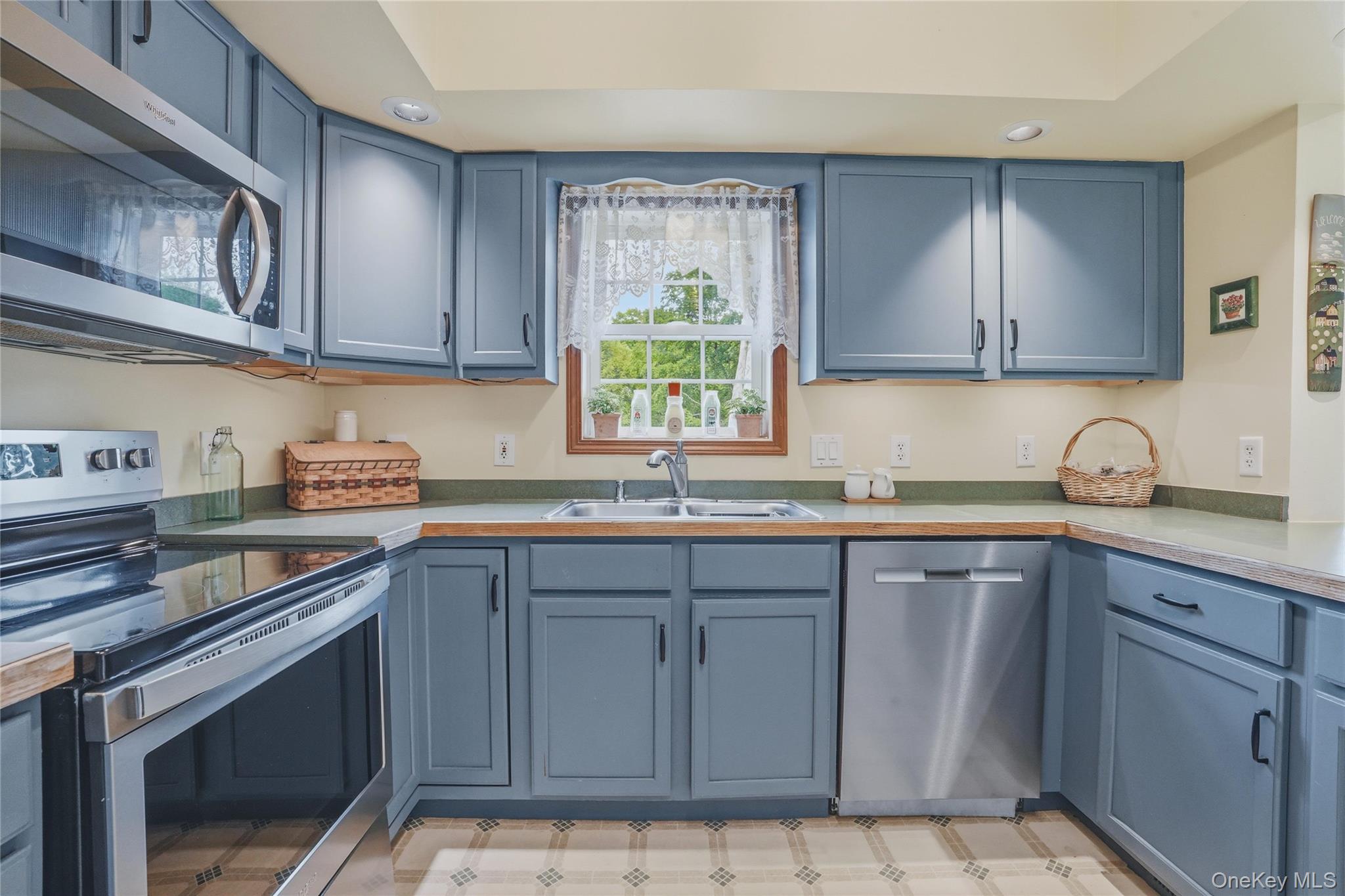 226 Cart Road, Unit C Dover Plains, NY 12522 - Photo 15 of 47 Kitchen with blue cabinets and stainless steal appliances