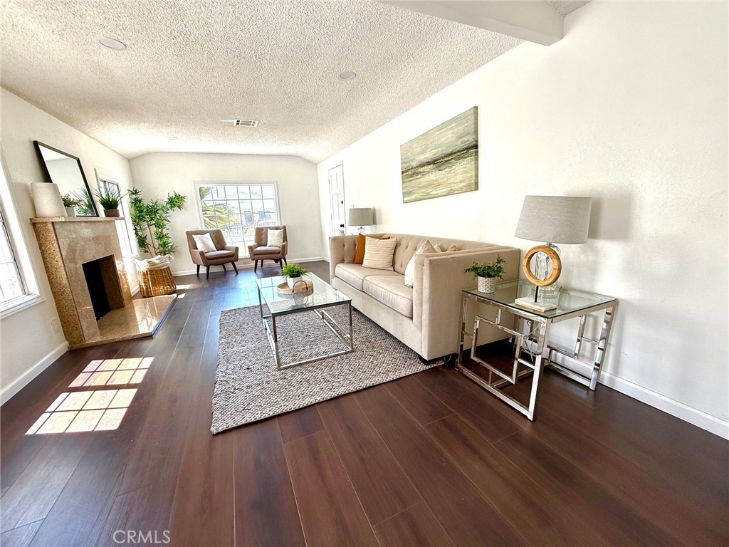 8231 Comolette Street Downey, CA 90242 - Photo 11 of 25 a living room with furniture and a fireplace