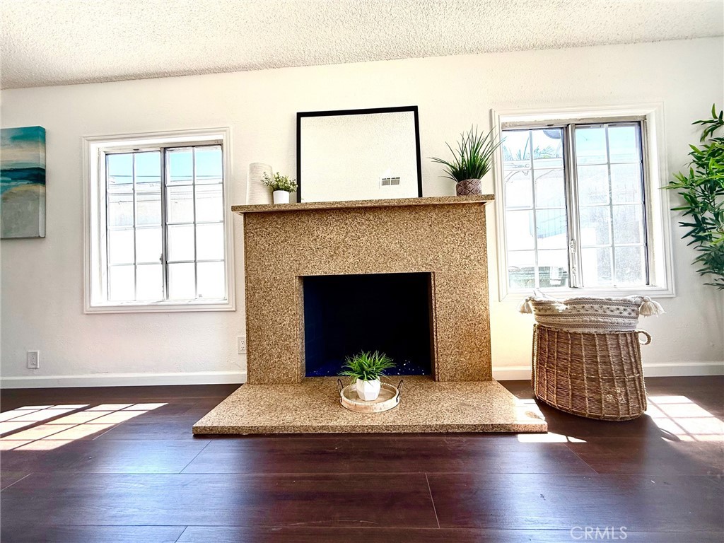 8231 Comolette Street Downey, CA 90242 - Photo 13 of 25 a living room with furniture and a fireplace
