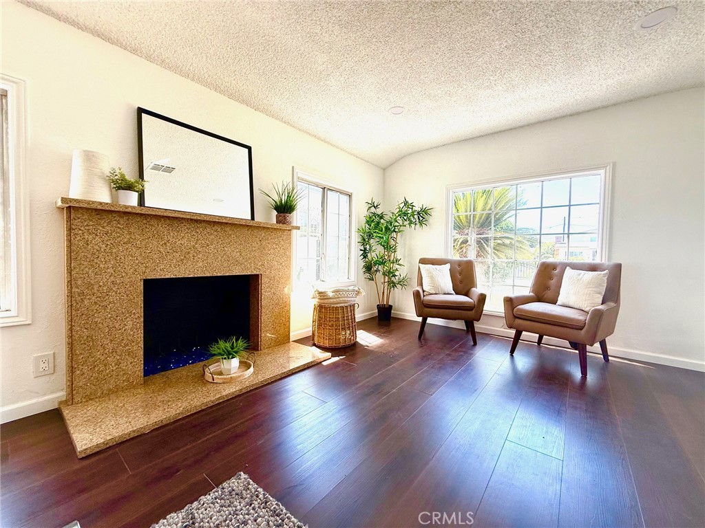 8231 Comolette Street Downey, CA 90242 - Photo 14 of 25 a living room with furniture and a fireplace