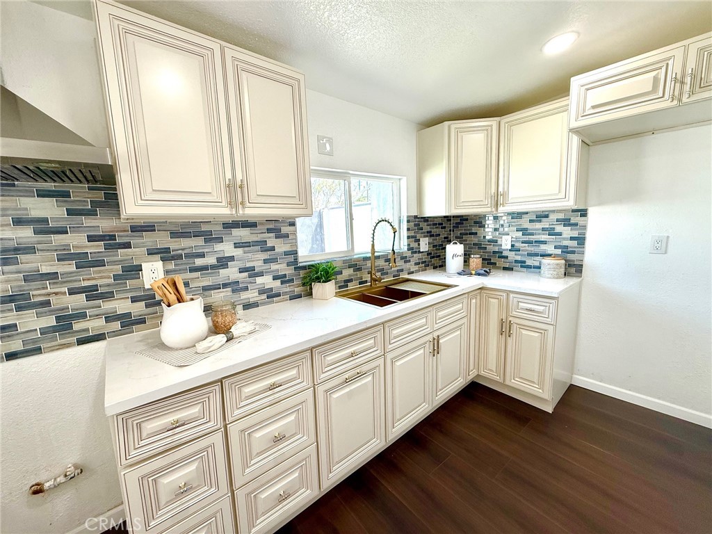 8231 Comolette Street Downey, CA 90242 - Photo 15 of 25 a kitchen with granite countertop white cabinets and white appliances