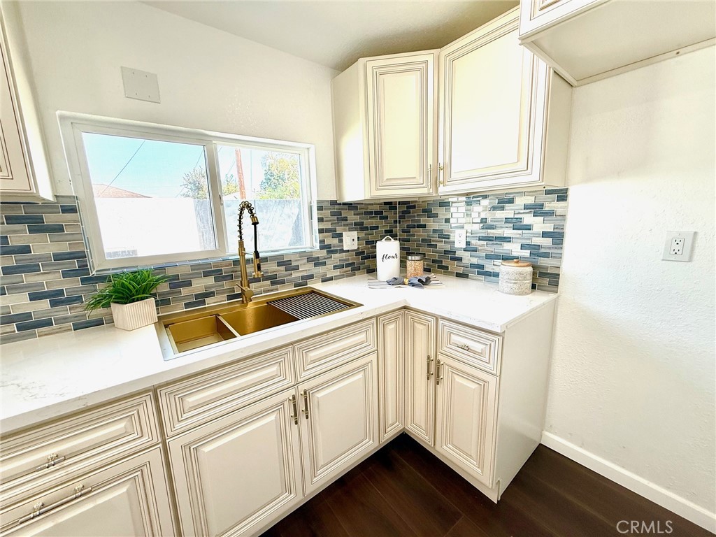 8231 Comolette Street Downey, CA 90242 - Photo 16 of 25 a kitchen with sink cabinets and window