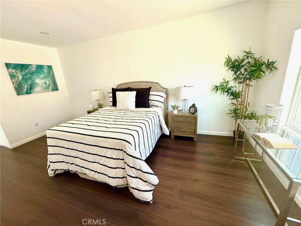 8231 Comolette Street Downey, CA 90242 - Photo 19 of 25 a bedroom with a bed and a potted plant