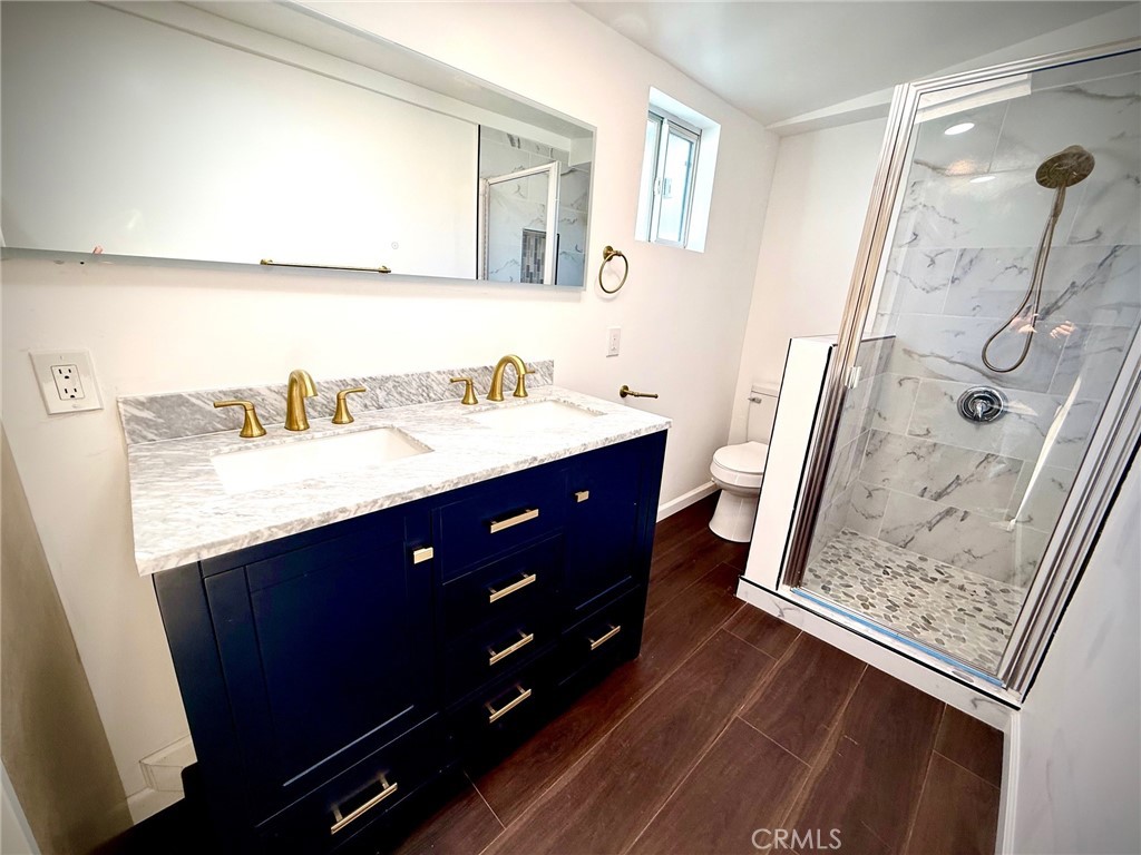 8231 Comolette Street Downey, CA 90242 - Photo 21 of 25 a bathroom with a sink vanity and a mirror