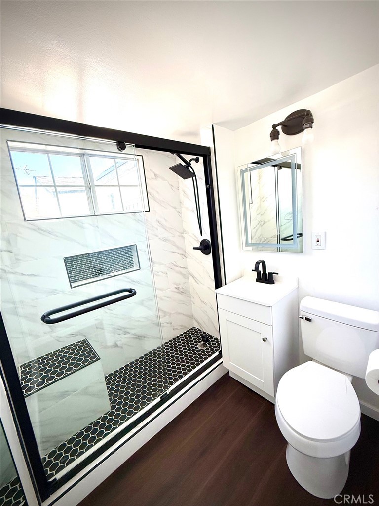 8231 Comolette Street Downey, CA 90242 - Photo 6 of 25 a bathroom with a sink toilet and mirror