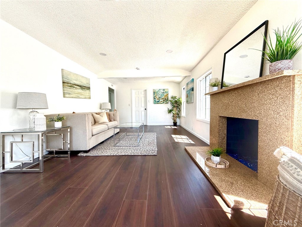 8231 Comolette Street Downey, CA 90242 - Photo 9 of 25 a living room with furniture fireplace and wooden floor