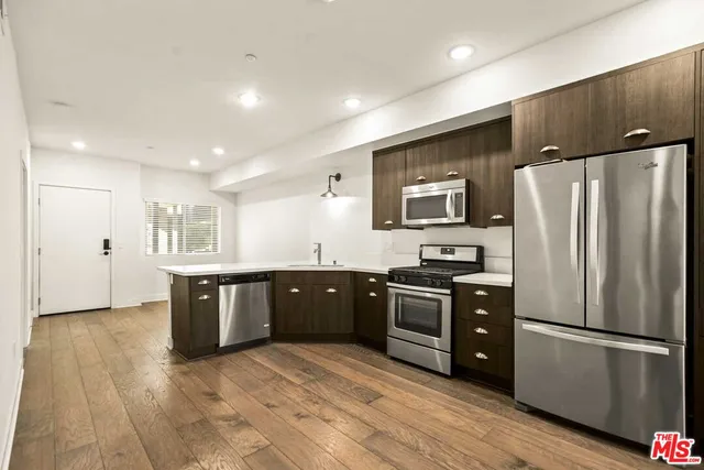 a kitchen with a refrigerator and a sink