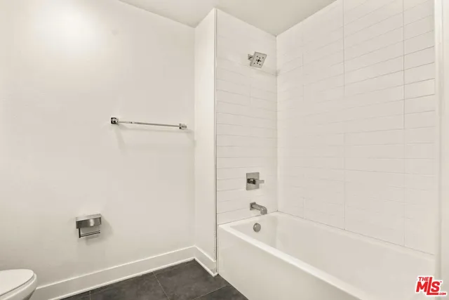 a bathroom with a bathtub a toilet and a shower