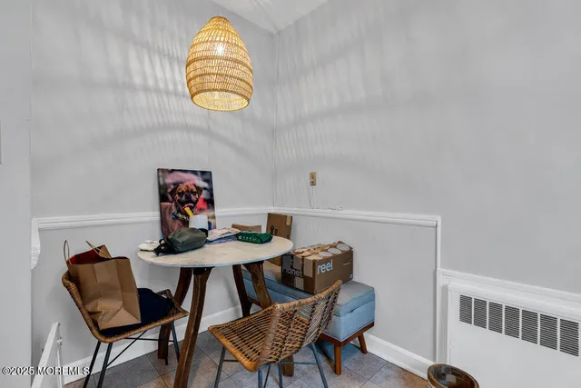 a view of a dining room with furniture and a window