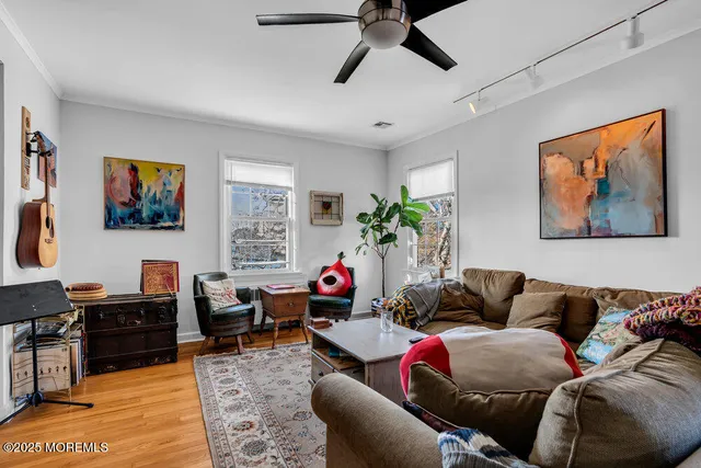 a living room with furniture kitchen view and a window