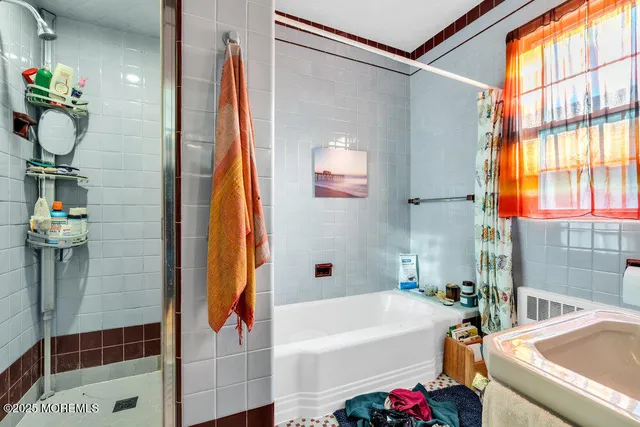 a bathroom with a bathtub and shower