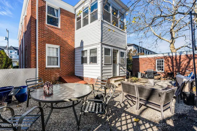 a view of a patio with table and chairs and potted plants
