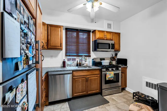 a kitchen with stainless steel appliances granite countertop a stove and a sink