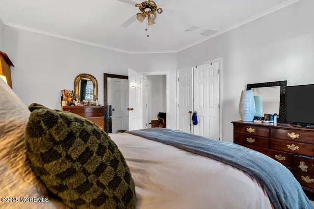 a bedroom with a bed and a television