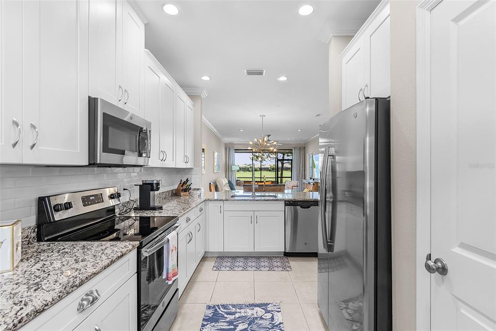 13703 Messina Loop, Unit 102 Bradenton, FL 34211 - Photo 17 of 74 a kitchen with a sink stainless steel appliances and cabinets