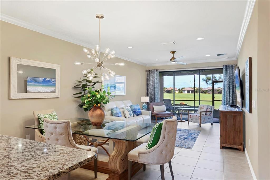 13703 Messina Loop, Unit 102 Bradenton, FL 34211 - Photo 20 of 74 a dining room with furniture a chandelier and wooden floor