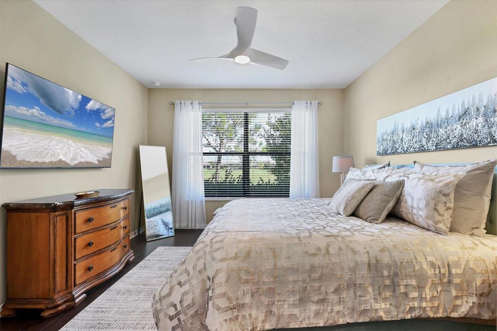 13703 Messina Loop, Unit 102 Bradenton, FL 34211 - Photo 24 of 74 a bedroom with a bed and a flat tv screen on dresser