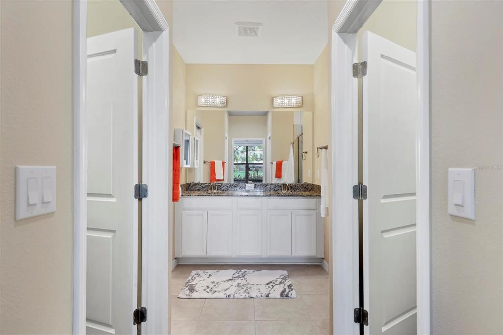 13703 Messina Loop, Unit 102 Bradenton, FL 34211 - Photo 25 of 74 a bathroom with a granite countertop sink and a mirror