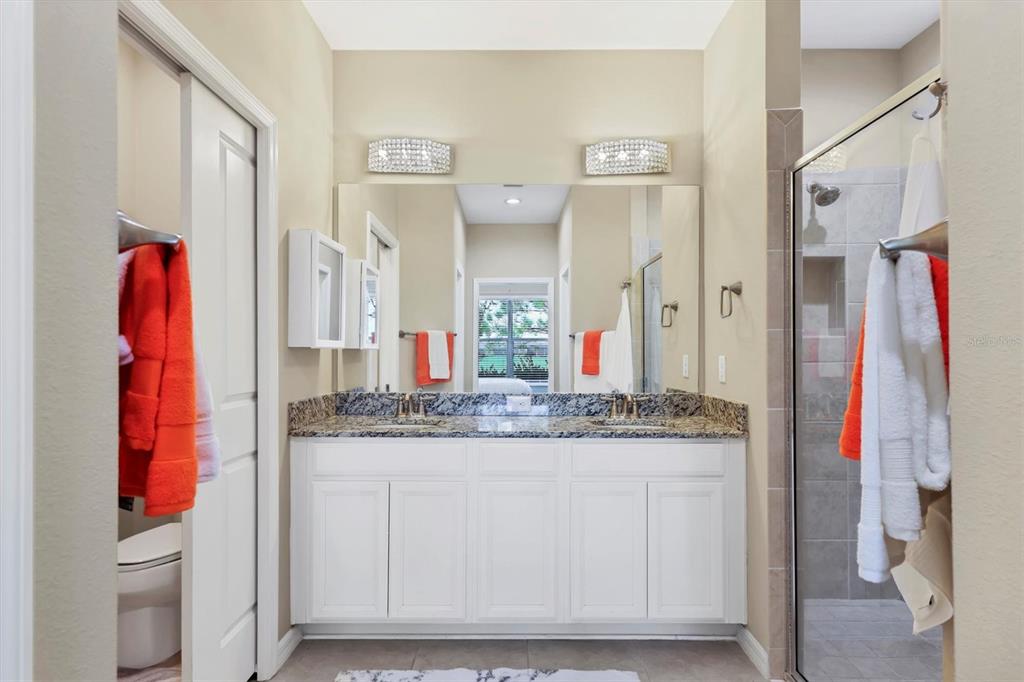 13703 Messina Loop, Unit 102 Bradenton, FL 34211 - Photo 26 of 74 a en suite bathroom with a granite countertop sink and a mirror