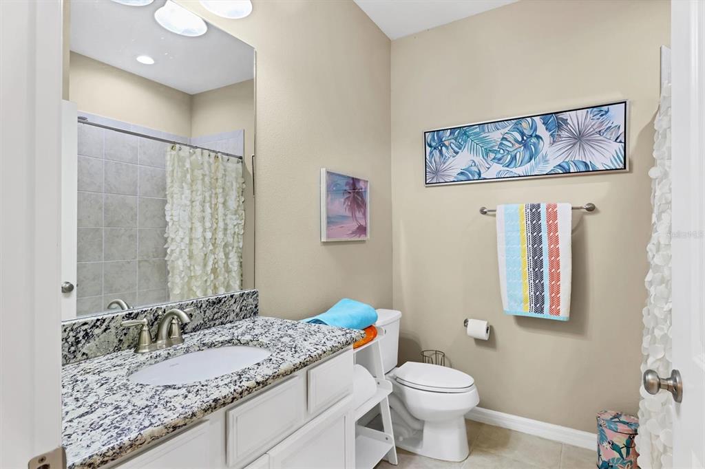13703 Messina Loop, Unit 102 Bradenton, FL 34211 - Photo 28 of 74 a bathroom with a granite countertop sink mirror vanity and toilet