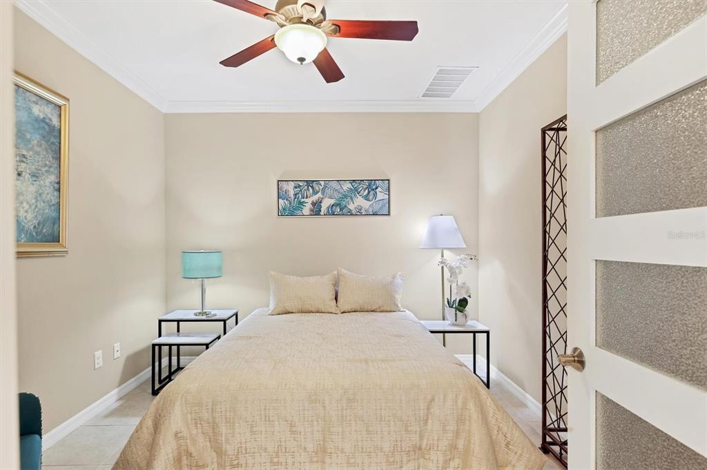 13703 Messina Loop, Unit 102 Bradenton, FL 34211 - Photo 29 of 74 a bedroom with a bed and a chandelier