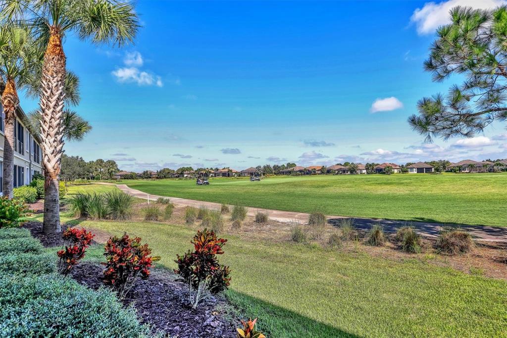 13703 Messina Loop, Unit 102 Bradenton, FL 34211 - Photo 33 of 74 a view of a lake with a house in the background