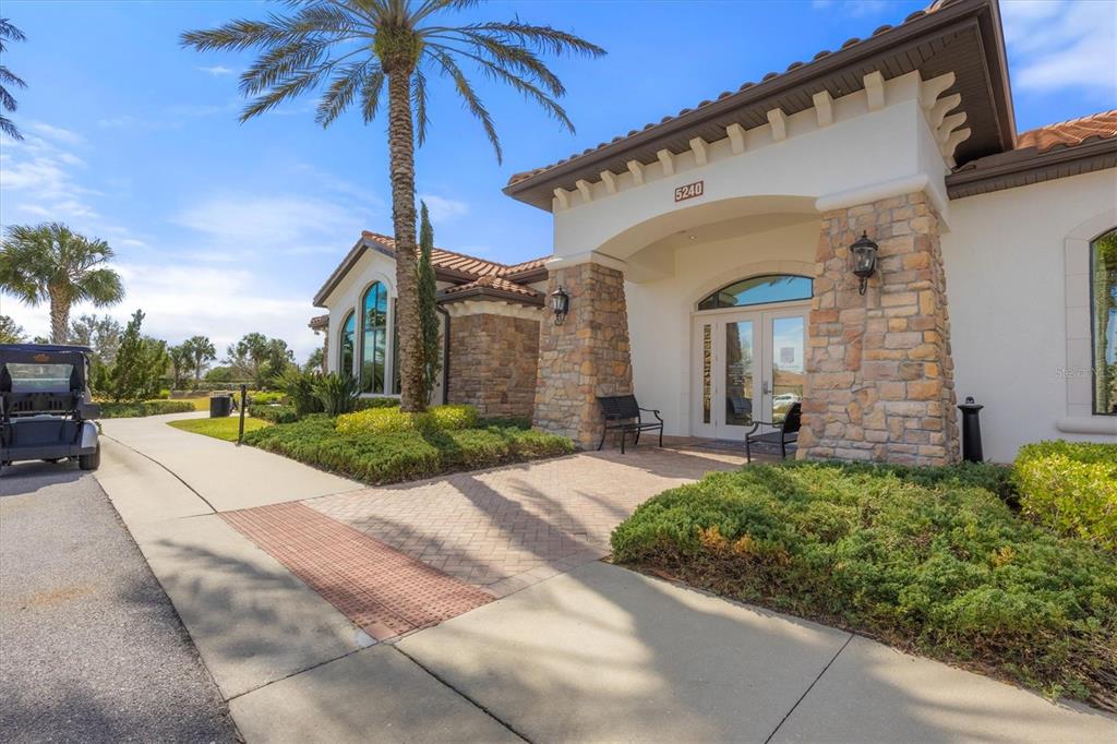 13703 Messina Loop, Unit 102 Bradenton, FL 34211 - Photo 67 of 74 a view of a white house with a large windows plants and palm trees