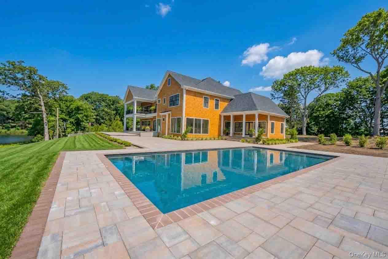 106 Cove Road Asharoken, NY 11768 - Photo 40 of 46 Outdoor pool with a patio area, a balcony, a lawn, and a sunroom