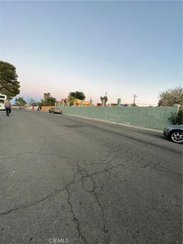 a view of a yard with wooden fence