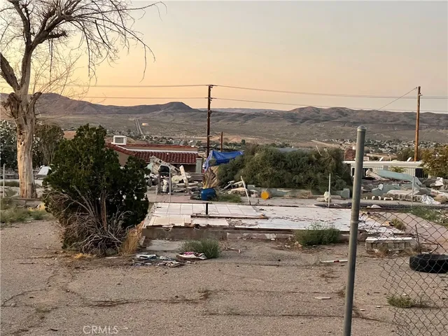 a view of a yard with wooden fence