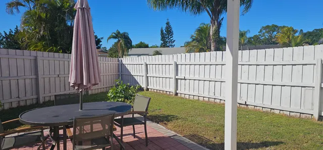 a view of a backyard with a chair and table