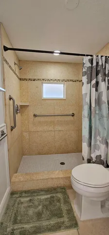 a bathroom with a toilet and shower