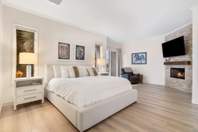 a living room with furniture a flat screen tv and a fireplace